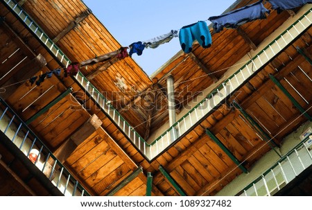 washed laundry is dried on a rope against the background of the morning sky and wooden balconies, the concept of a genuine old courtyard, copy space, close-up
