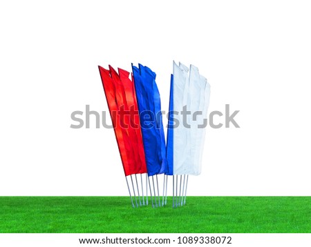 Blank vertical flags isolated on white background. White, blue and red flags on a green lawn. Template