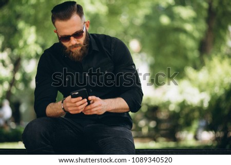 Man with phone in park