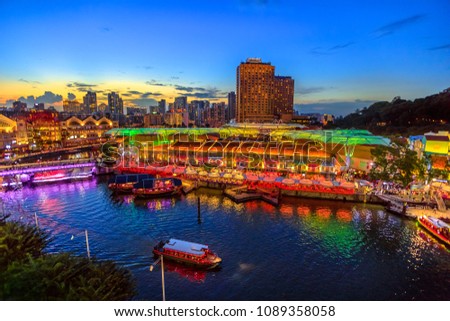 Scenic aerial view of Clarke Quay and Riverside area at blue hour in Singapore, Southeast Asia. Waterfront skyline reflected on Singapore River. Popular attraction for nightlife. Royalty-Free Stock Photo #1089358058
