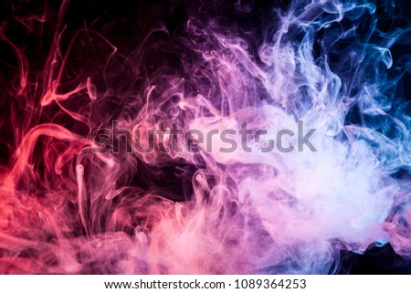 Dense multicolored  purple, red and blue smoke  on a black isolated background. Background of smoke vape