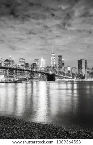 Black and white picture of Manhattan waterfront at night, New York City, USA.