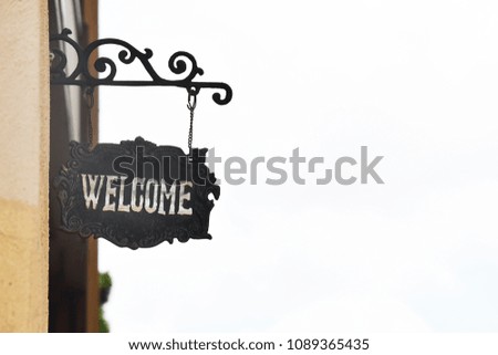 The sign “ welcome “ on the wall of resort.