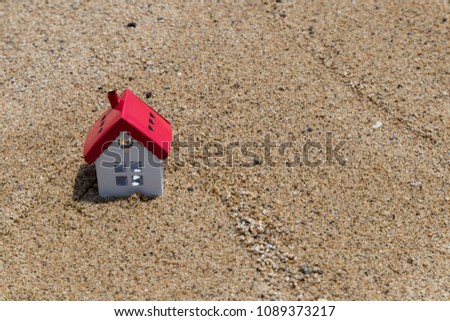 real estate and mortgage investment.house and clock on the sand in the beach.Being an easy way homeowner.