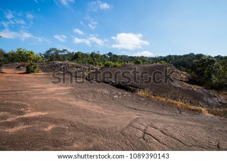 blue sky with clouds above the brown dried ground in forest at national park . crack surface background on clay soil