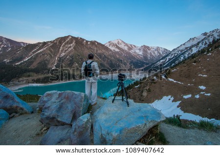 photographer takes a sunset in the mountains, a mountain lake, Kazakhstan, Almaty
