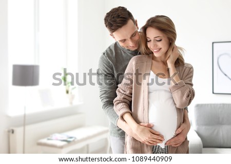 Young pregnant woman with her husband at home Royalty-Free Stock Photo #1089440909