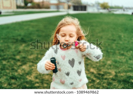 Little happy pretty girl outdoor in the park