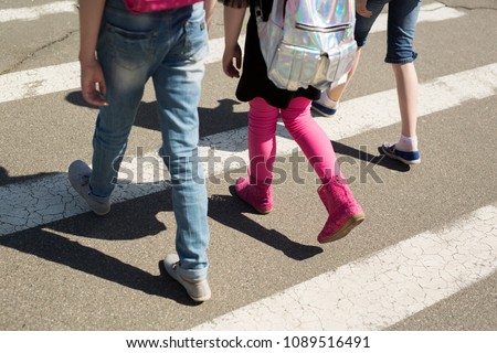 Schoolchildren crossing the road on their way to school
