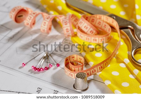 DIY concept. Sewing supplies: sewing thread, scissors, a spool of thread, pieces of cloth, needles,centimeter  .The inscription on the pattern: The Middle Line, The Cut line, Cut