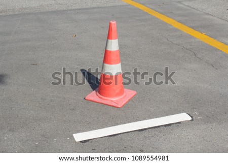 Orange rubber funnel on the asphalt road sign drive be careful.
