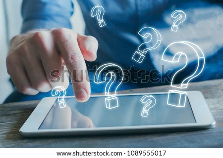 many quiestion marks from the screen of tablet computer, find answer online, FAQ concept, what where when how and why, search information on internet Royalty-Free Stock Photo #1089555017