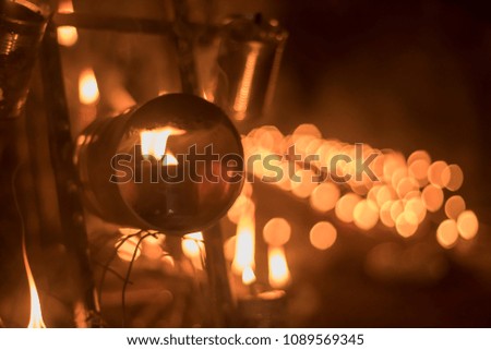 A traditional oil lamp  also known as pelita with blurry background effect during night time.