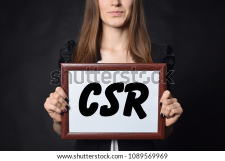 In the hands of a businessman a frame with the inscription:CSR
