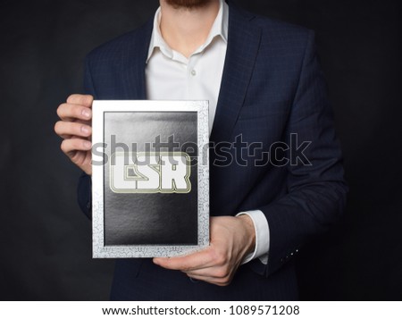 In the hands of a businessman a frame with the inscription:CSR