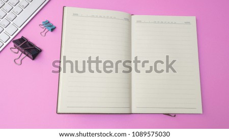 notebook and paper cilp with keyboard on pink  background. Pastel color Minimal concept