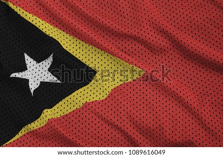 Timor Leste flag printed on a polyester nylon sportswear mesh fabric with some folds