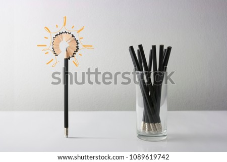 One different Pencil with light bulb . Individuality,Idea, independence, leadership and uniqueness concept. Stand out from the crowd. Think outside the box. Dare to be different.