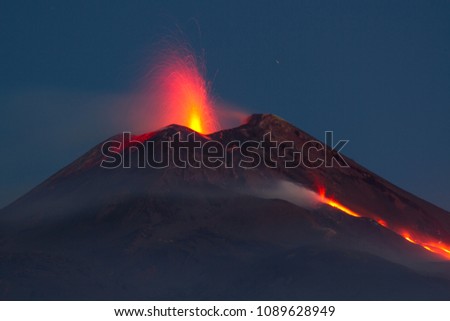 Mount Etna in eruption with lava flow at night. View from the Valle del Bove
 Royalty-Free Stock Photo #1089628949