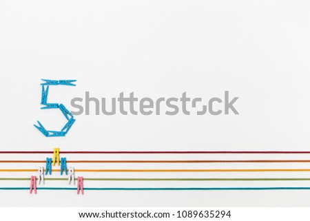 Coloured wooden cloths pin set or office clips. color strings of 5 line pattern on white background.
