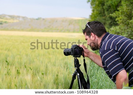 Male photographer using tripod for landscape photography