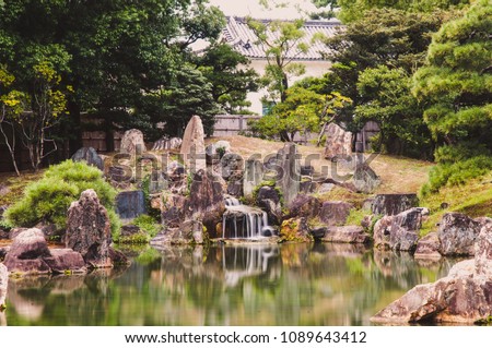 Gentle flowing waterfall in japanese garden in the emperial castle of Kyoto