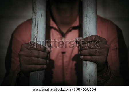 Hands of men desperate to catch the iron prison,prisoner concept,thailand people,Hope to be free,crime should be punished more severely,A person guilty are punished.