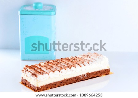 Rich, creamy philadelphia Classic Cheesecake and blue box on white background. Ice cream cake on wooden table. Shavuot, holiday, lifestyle, happy moments concept. Selective focus.