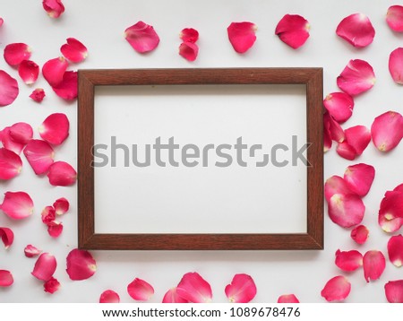 Wooden frame blank for greeting, with  Rose petals around frame.