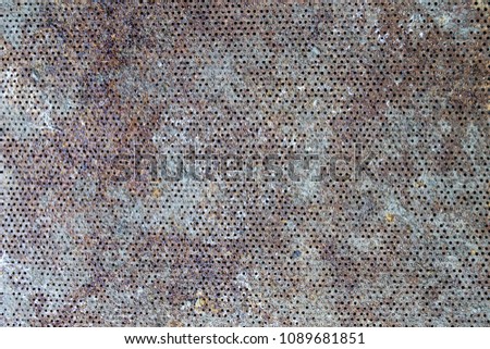 Texture of rusty metal into small holes