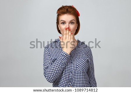 Omg. Cute girl expressing full disbelief, covering mouth. Picture of astonished beautiful young woman keeping hand on her lips, being shocked with big sale prices on web stores. Body language