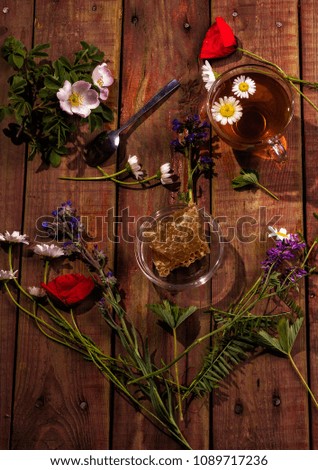 Cup of herbal tea on dark aged rustic background, top view, place for text, border