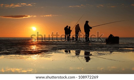 Fisherman on sunrise on the pier Royalty-Free Stock Photo #108972269