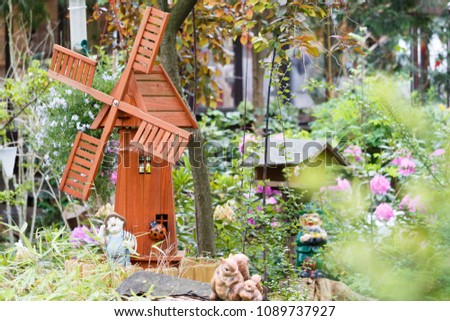nostalgic front garden with gnomes and windmill