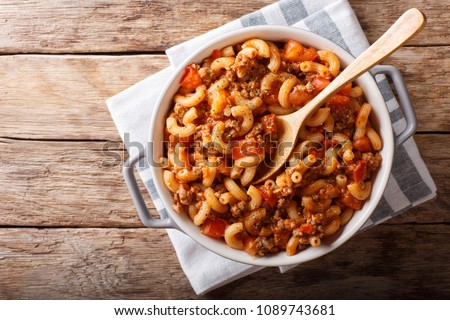 american chop suey, american goulash, with elbow pasta, beef and tomatoes close-up in a saucepan. horizontal top view from above
 Royalty-Free Stock Photo #1089743681