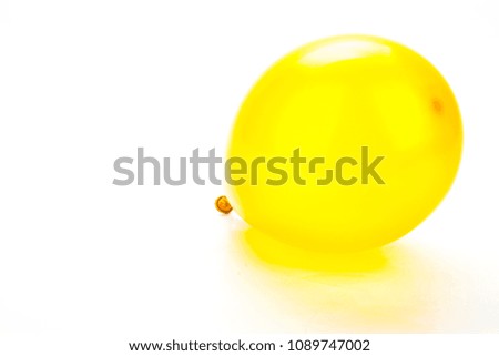 Blank golden yellow rubber inflatable balloon. New Year event and birthday celebration concept. Detailed close up studio shot isolated on a white background