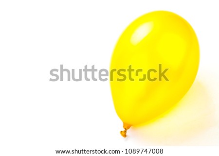 Blank golden yellow rubber inflatable balloon. New Year event and birthday celebration concept. Detailed close up studio shot isolated on a white background