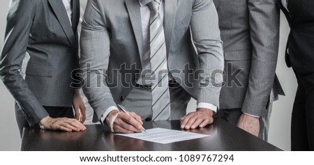 Group of business people sign a contract finishing deal