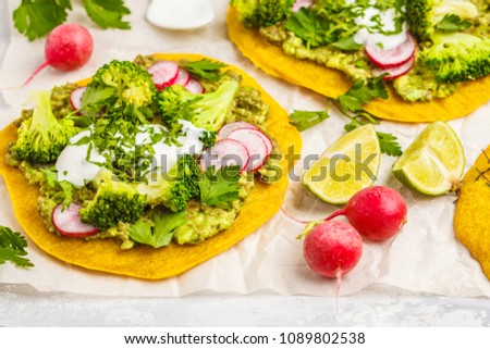 Vegan pizza (tacos) with radish, broccoli and guacamole. Healthy vegan food concept.