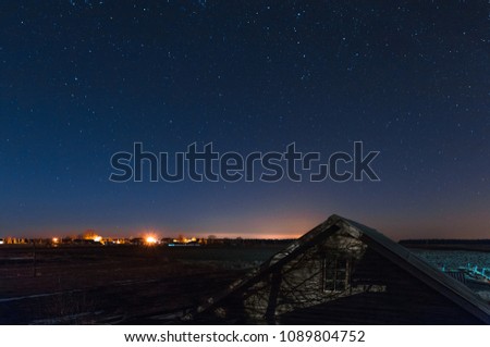 blue and starry sky against the backdrop of the distant lights of the city