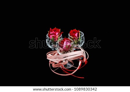 Roses in the glass on a dark background