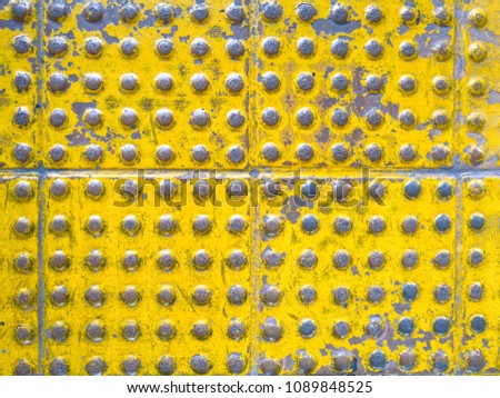 top view old blindblock texture, rough tactile surface background, close up yellow brick road, peeling paint braille block on the floors