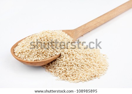 Wooden spoon with sesame seeds on a white background Royalty-Free Stock Photo #108985895