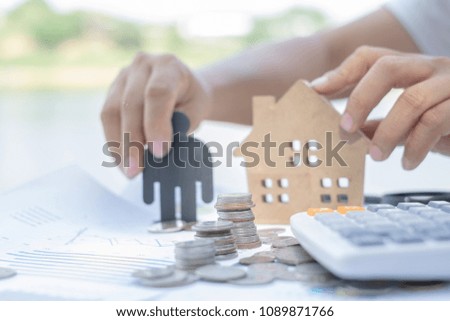 House model, piles of coins and calculator calculate for pay loan, Saving money for real estate concept