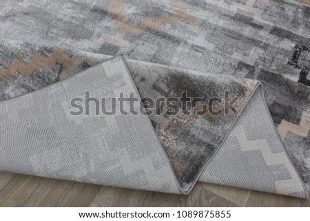 Close-up carpet on laminate wood floor in living room, interior decoration