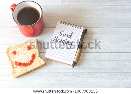 Cup Of Coffee And Smiling Face Toast Of Jam With Notes Good Morning On Table From Above.