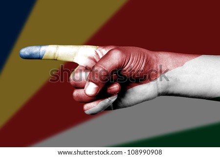 Human hand point with finger in Seychelles national flag