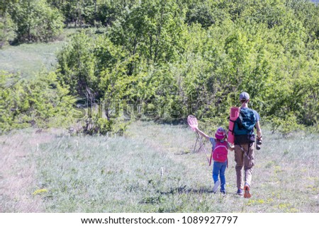 father with his daughter  in a hike through the mountains