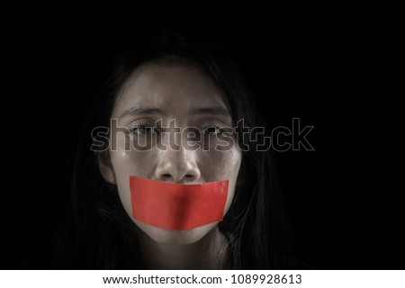 Image of young woman looks cried with her mouth covered by adhesive tape  Royalty-Free Stock Photo #1089928613