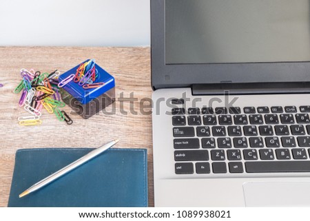 Magnetic box  for put paper clips and Paper Clips colorful on the side of the notebook on wooden floor